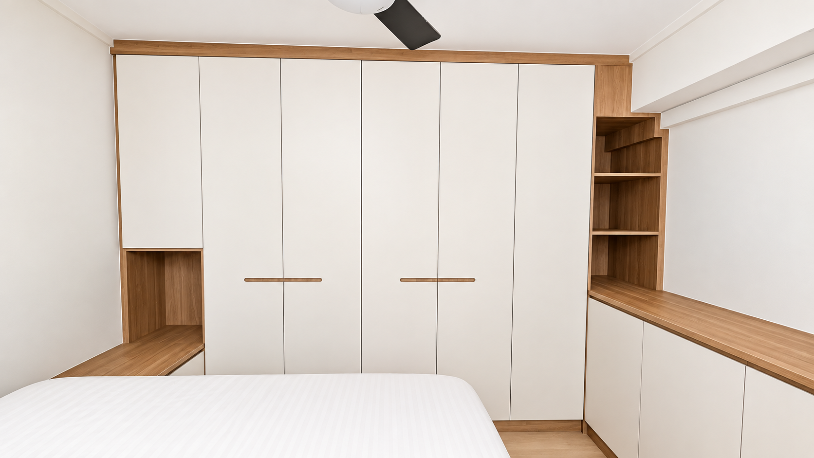 Front-on wardrobe view showing cream doors, oak handles and open shelving column at right