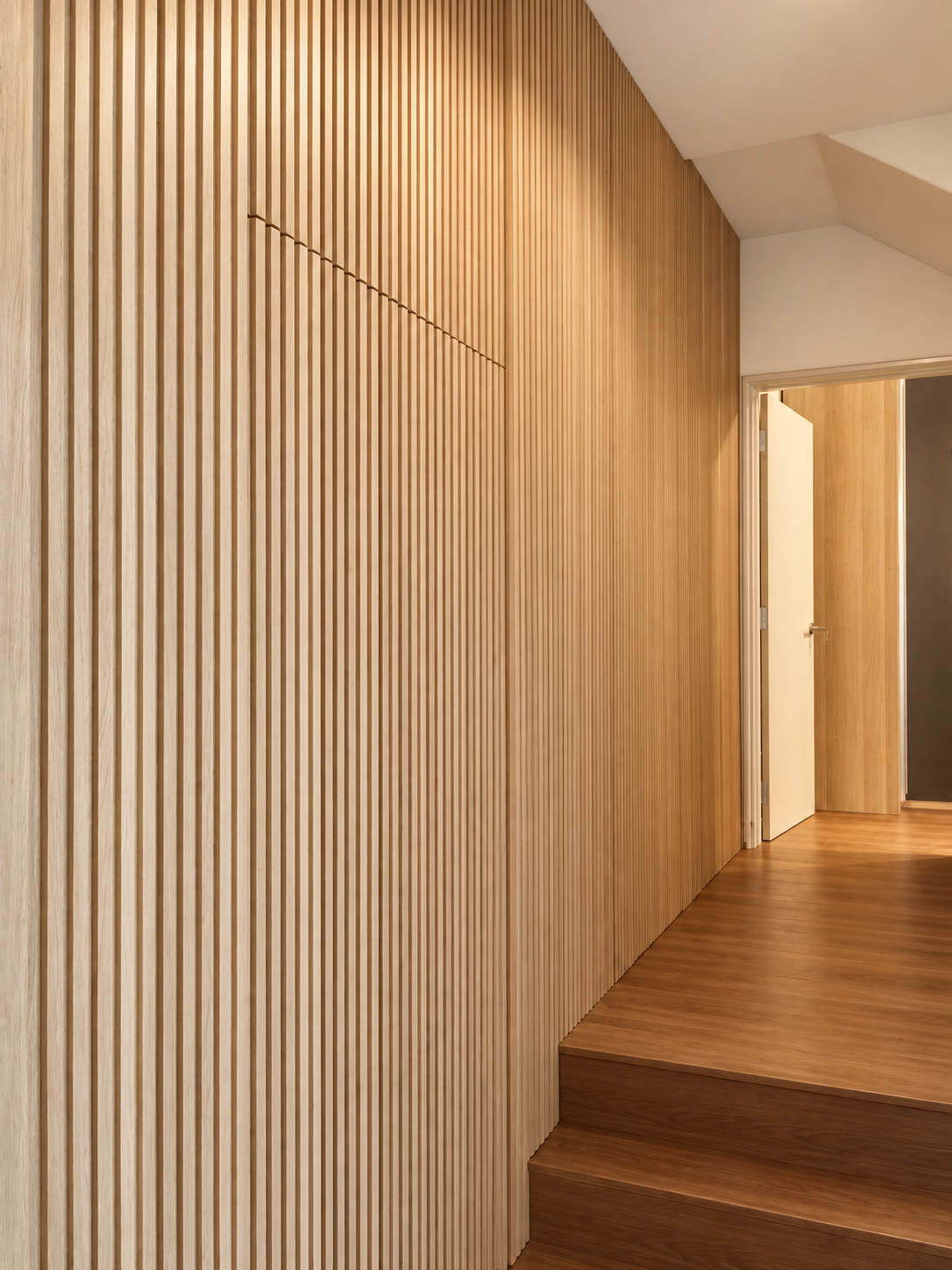 Side angle showing pantry towers and fluted oak staircase wall